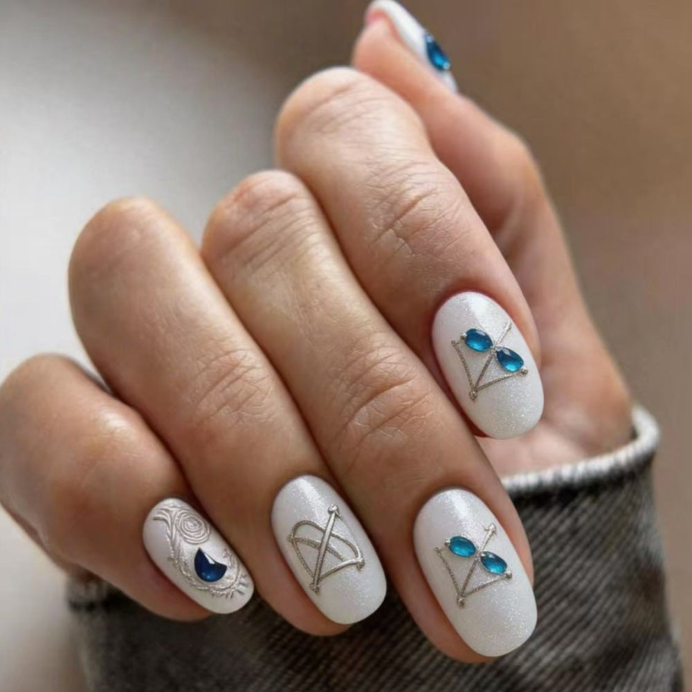 Artificial nails with elegant jewelry embellishments Kalsten