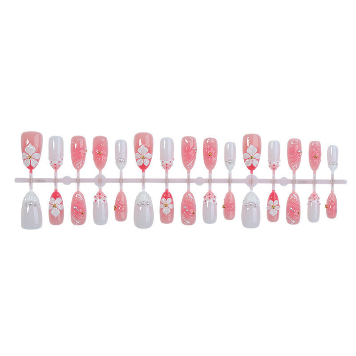 Creative acrylic nail set with floral accents and glitter decorations Kalsten