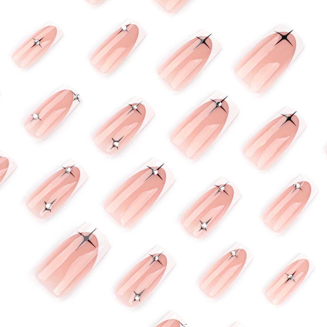 Artificial nail extensions with elegant French tip and glitter accents Kalsten