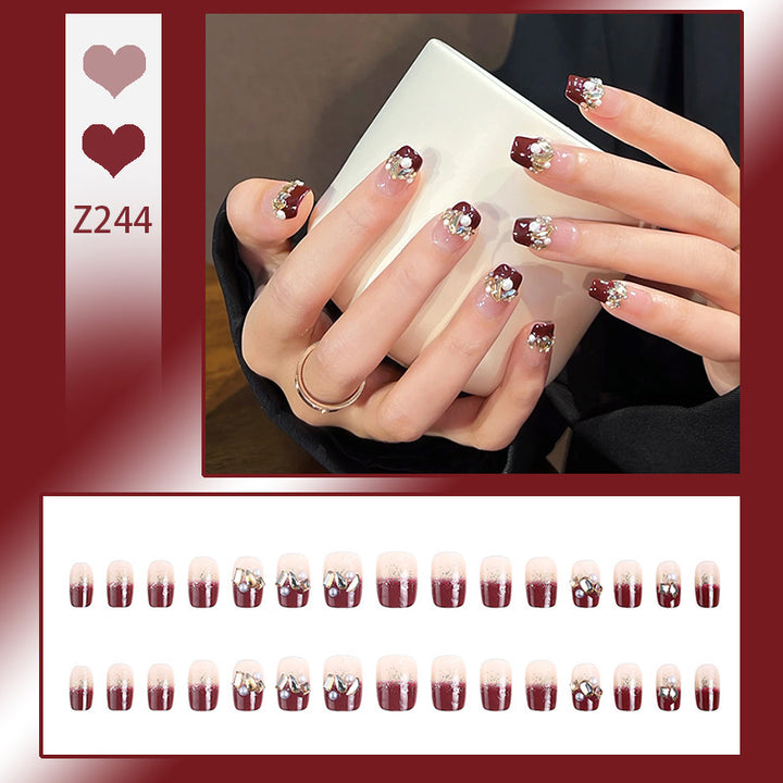Glamorous artificial nails with decorative pearl and glitter embellishments Kalsten