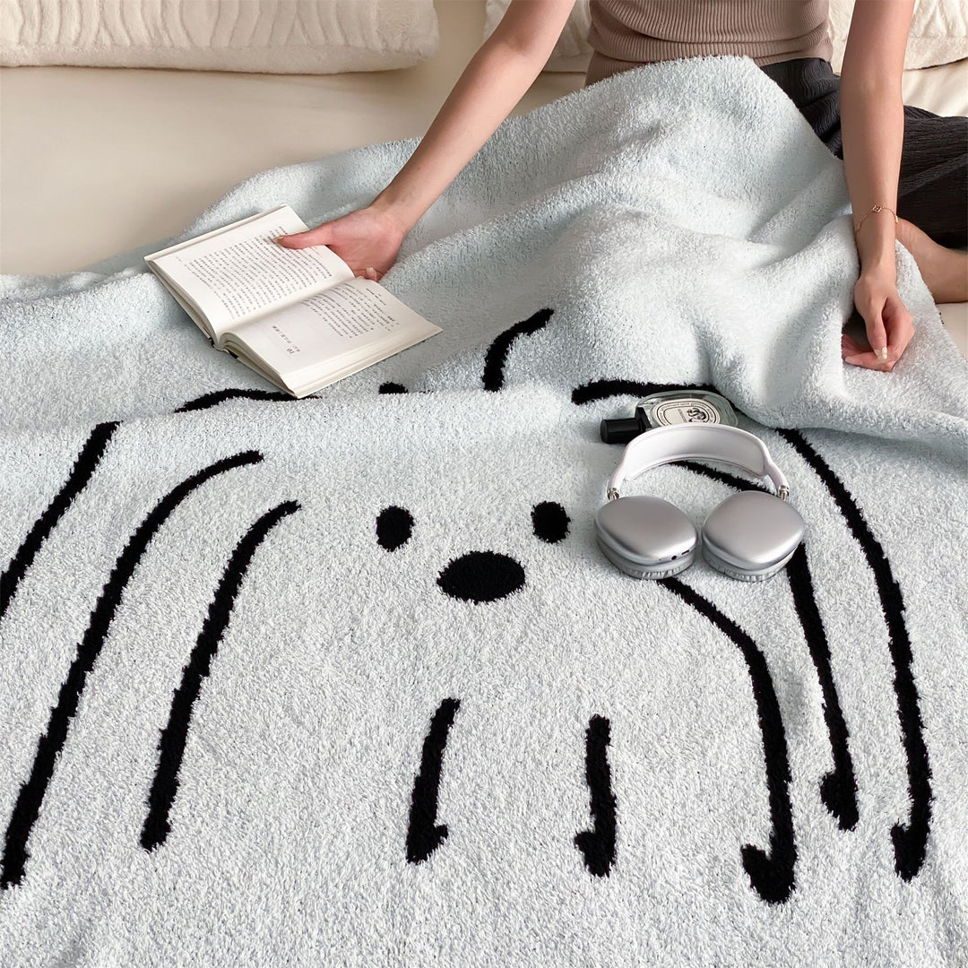 Reversible cuddly blanket made of terry cloth with decorative dog motif
