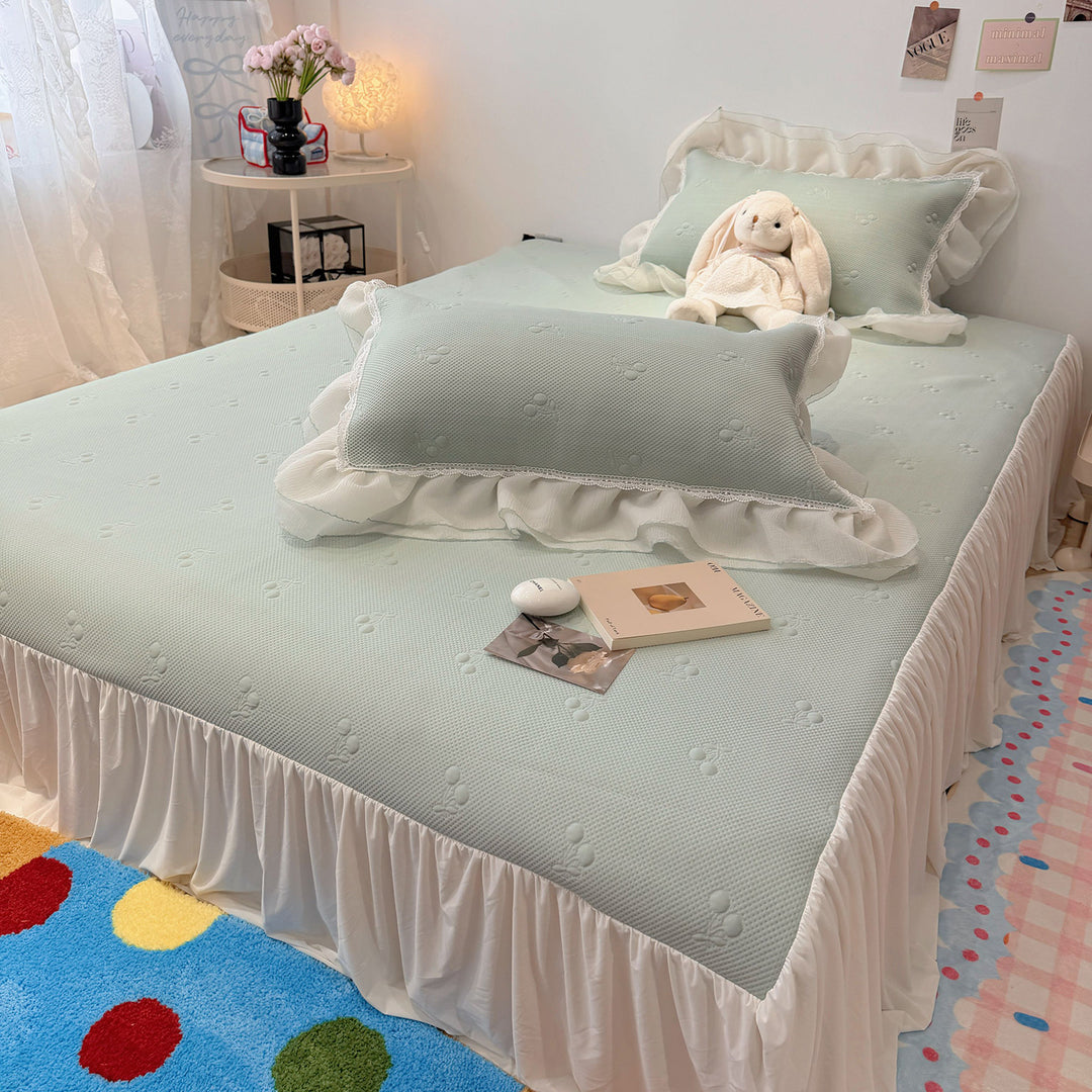 Quilted bedspread with ruffle and delicate floral quilting