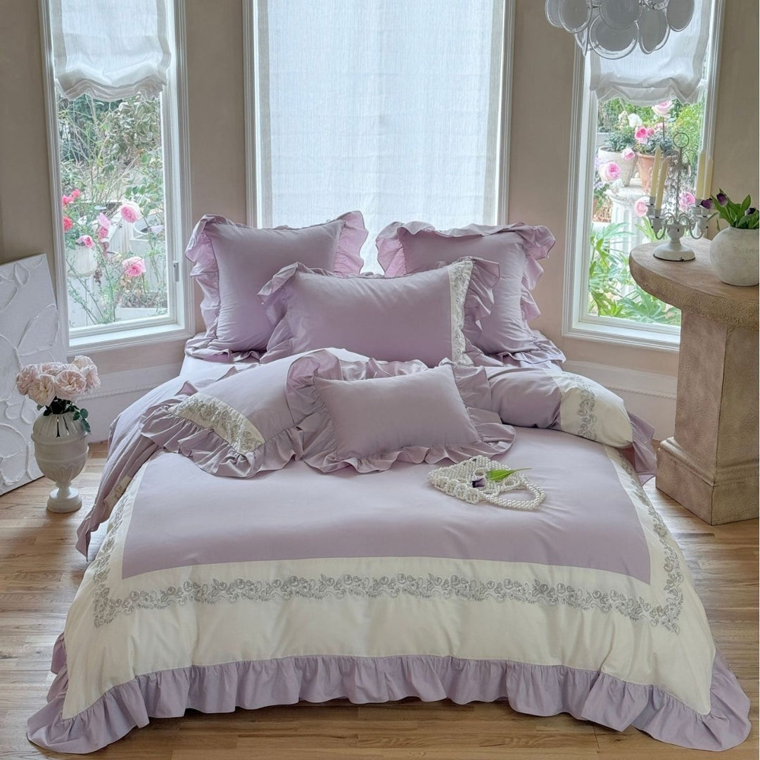 Designer bed linen set with ruffle hem and fine border embroidery