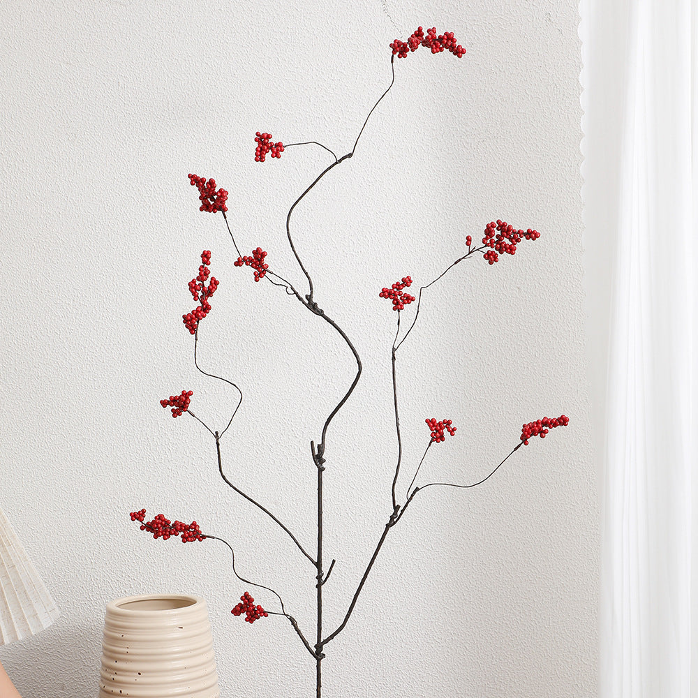 Decorative artificial flower branch with glowing red berries