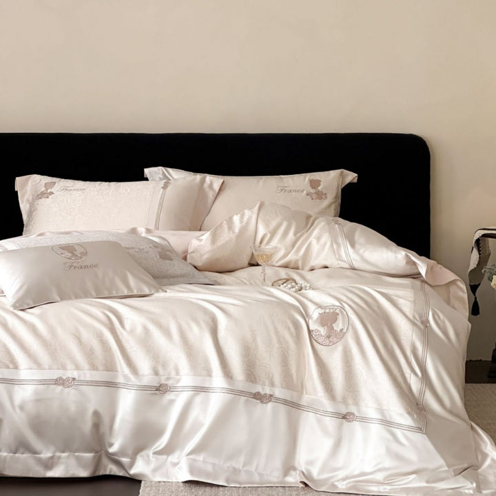 Luxurious cotton satin bed linen set with jacquard rose pattern and embroidered silhouette applications