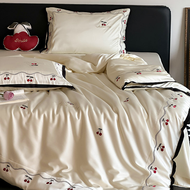 Noble satin bed linen set with cherry applique, decorative piping and frill