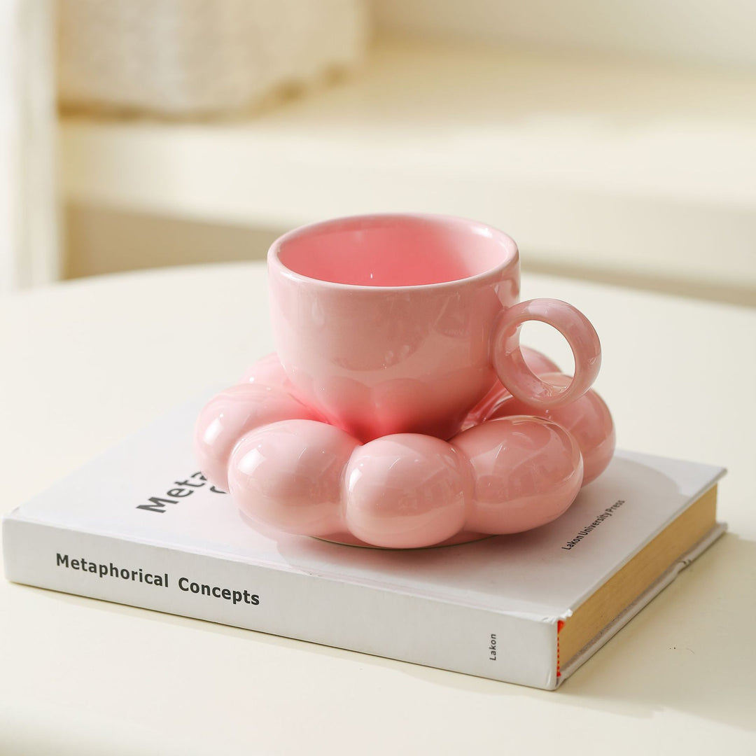 Ceramic mug with sculptural bubble saucer