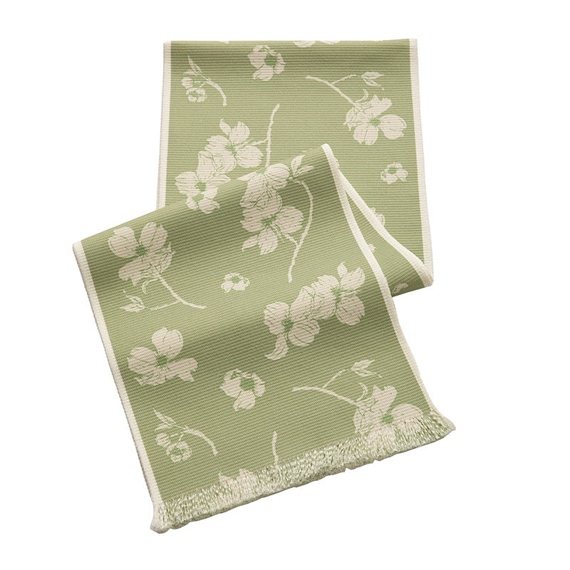 Woven botanical table runner with olive branch motif and fringed edge