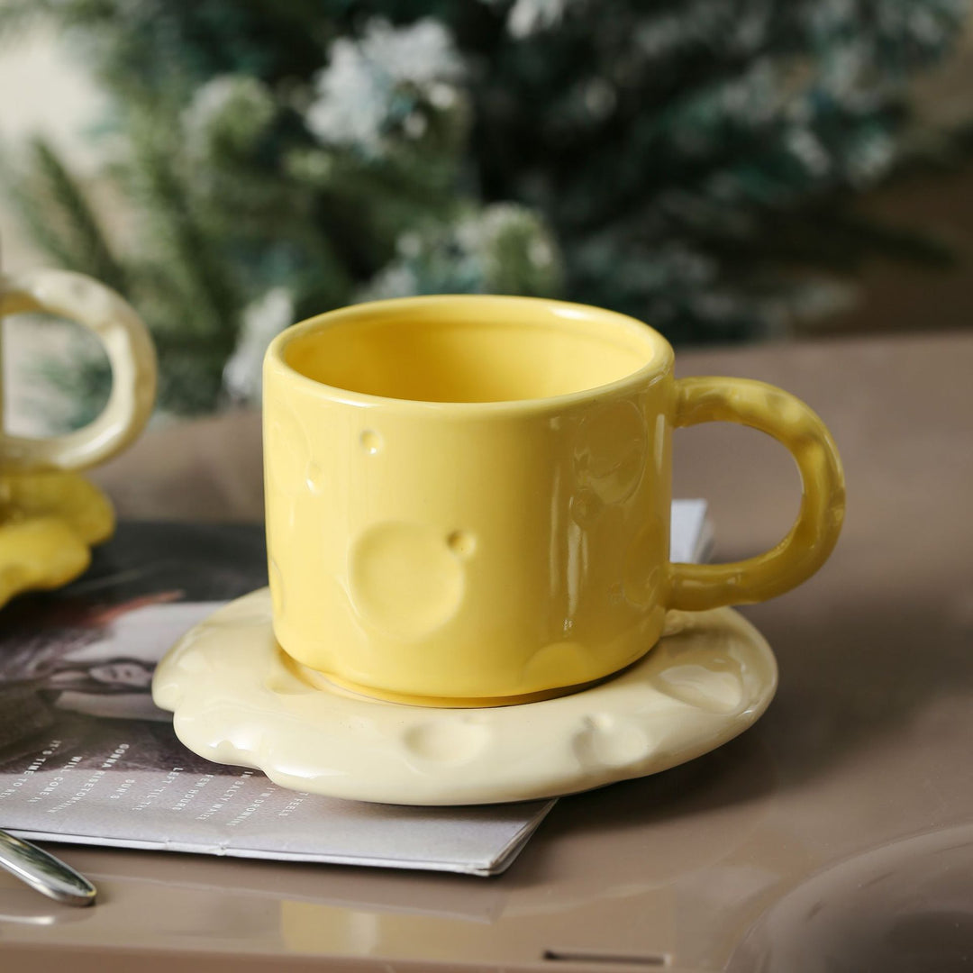 Sculptural ceramic cup set with flowing glaze and textured saucer