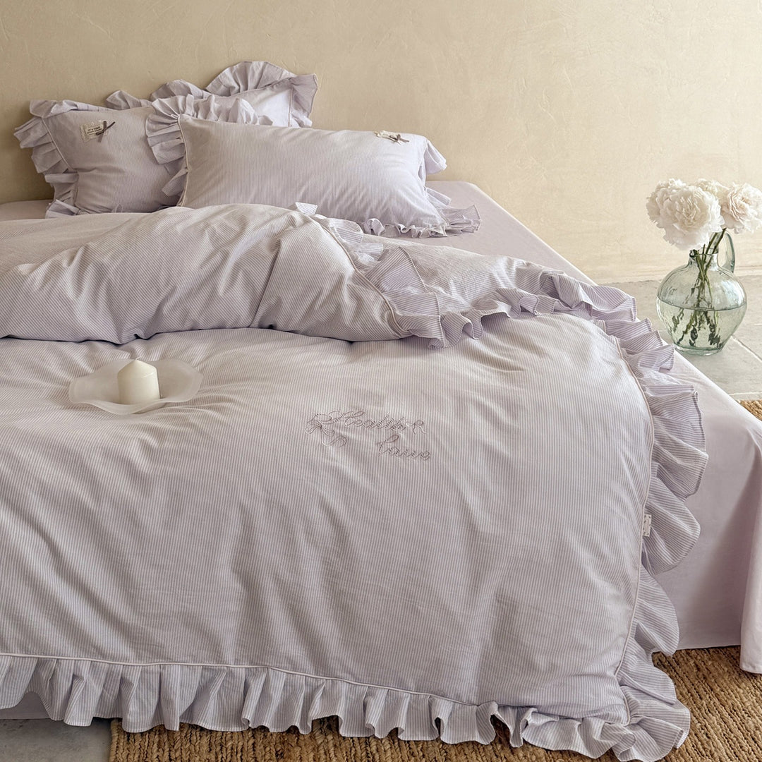 Ruffled bed linen set with fine striped texture and decorative frill