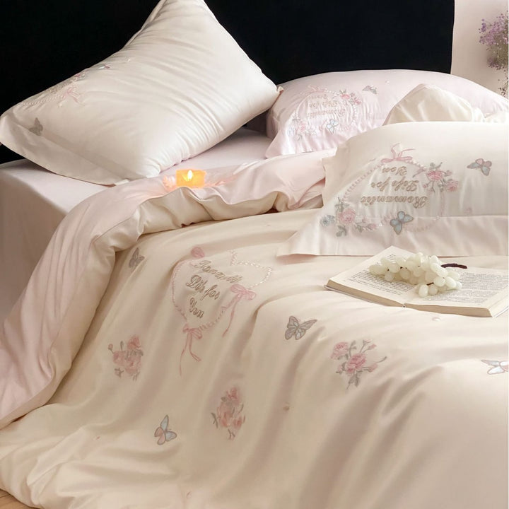 Luxurious embroidered cotton satin bedding set with delicate butterfly and flower appliqués