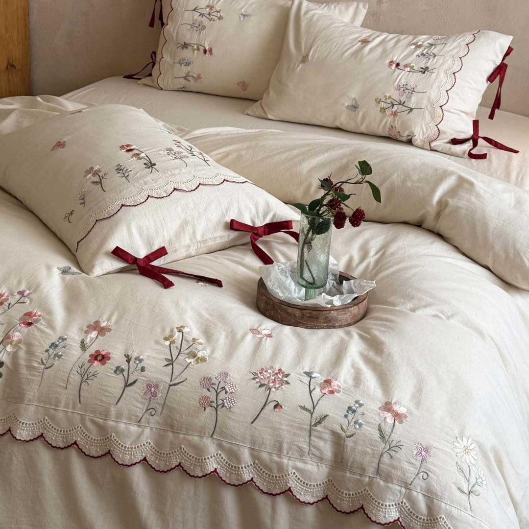 Embroidered bed linen set with lace trim and decorative bows