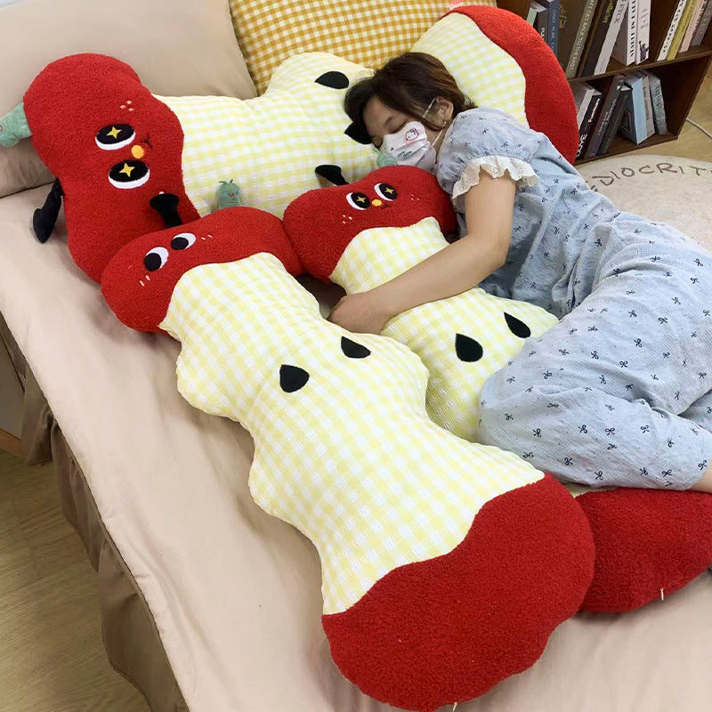 Extra-long ergonomic cuddle body pillow in apple core design with gingham cover and soft plush ends