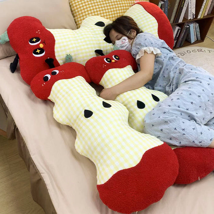 Extra-long ergonomic cuddle body pillow in apple core design with gingham cover and soft plush ends
