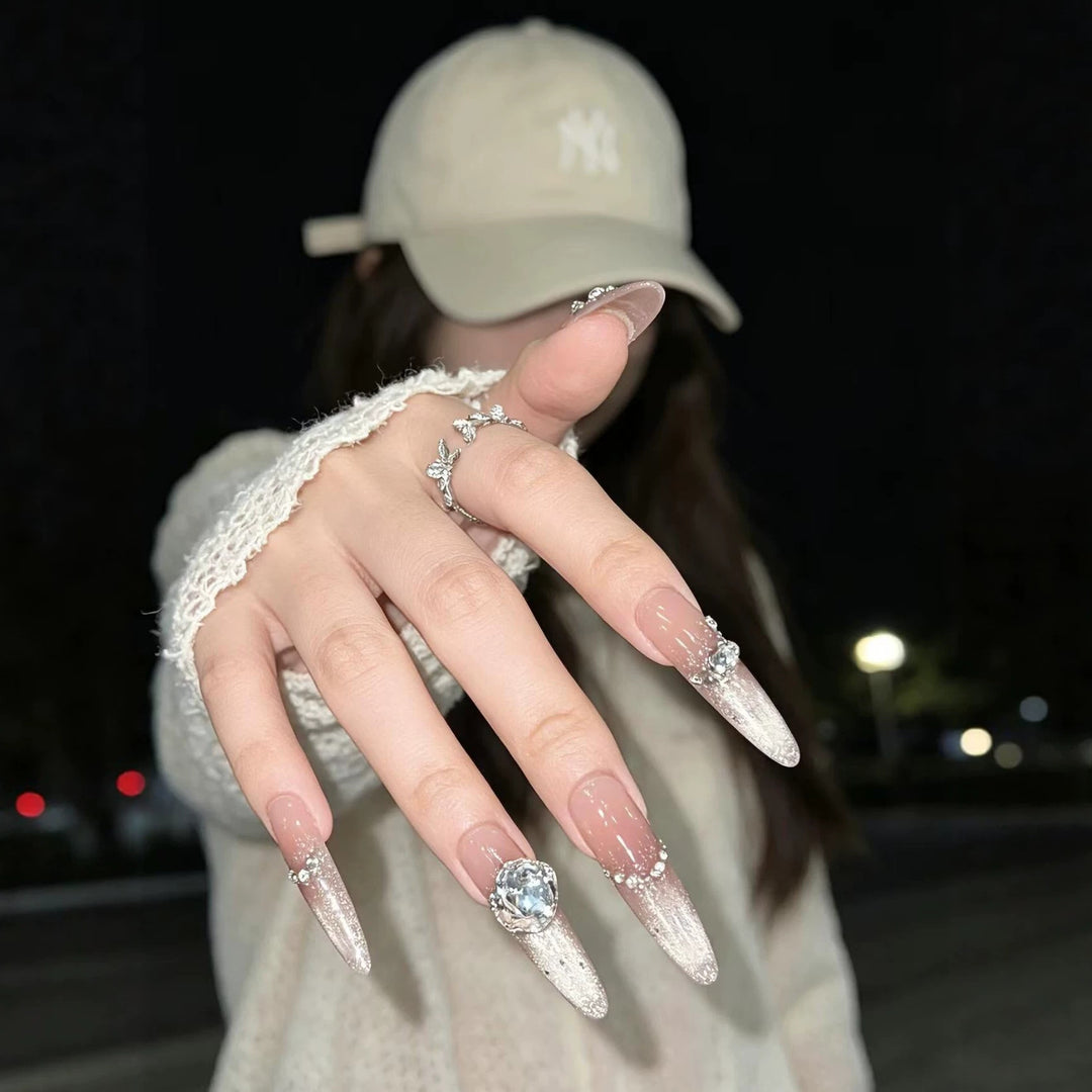 Artistic Stiletto Nail Enhancements with Gemstone Accents