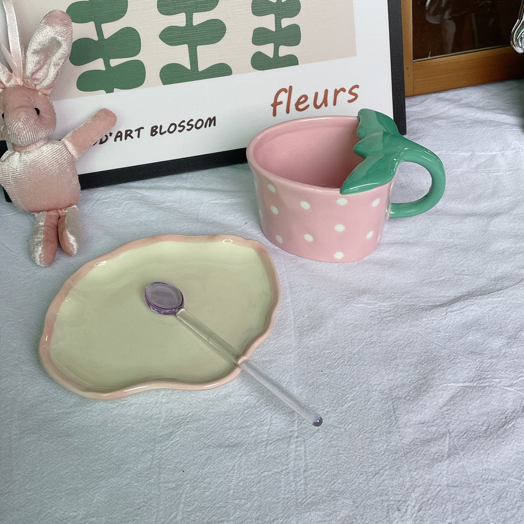 Playful ceramic mug with shaped leaf handle, saucer, and tulip spoon