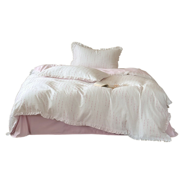 Bedding set made of lightweight cotton muslin with fine line embroidery and ruffled border