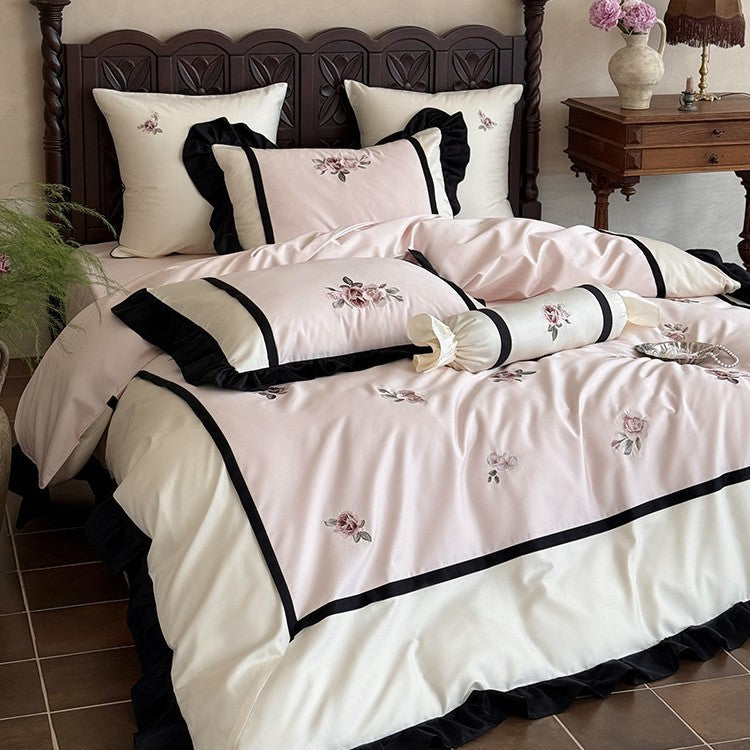 Luxurious embroidered bed linen set made of cotton satin with ruffles and decorative pillows