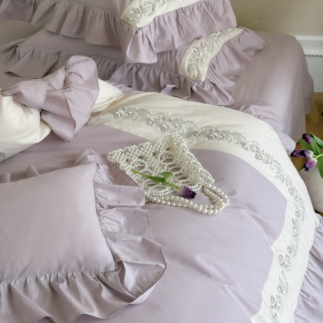 Designer bed linen set with ruffle hem and fine border embroidery