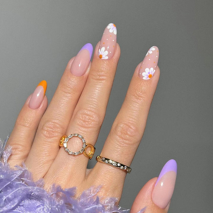 Artful nail art with floral accents and gradient colors Kalsten