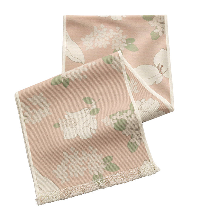 Woven botanical table runner with olive branch motif and fringed edge