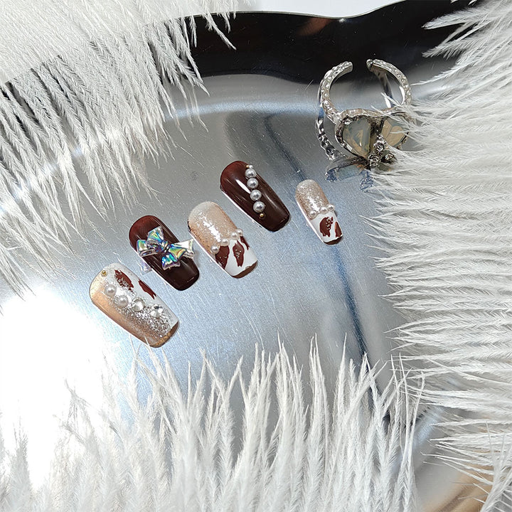 Artificial nails with glamorous rhinestone and bow design Kalsten