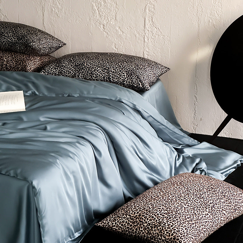 Satin bedding set with a silky sheen, smooth drape, and animal print pillows