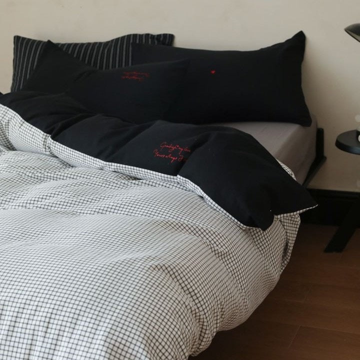 Cotton bedding set with fine check pattern, black reversible side and embroidered heart accents