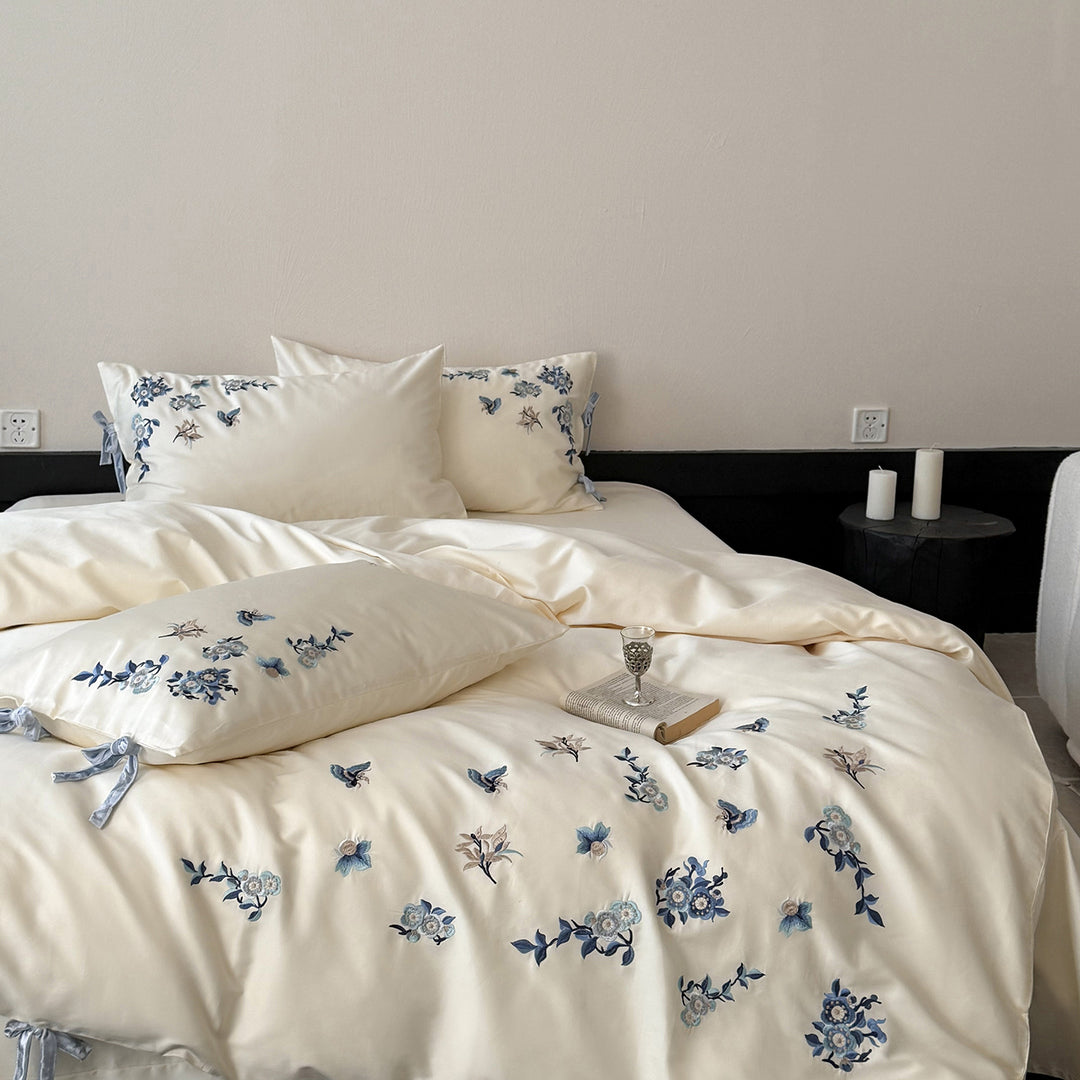 Embroidered satin bedding set with delicate floral details