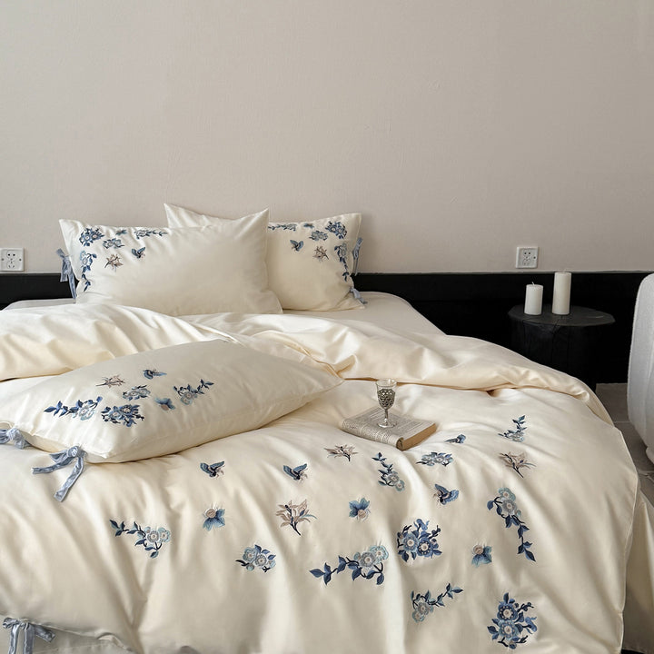 Embroidered satin bedding set with delicate floral details