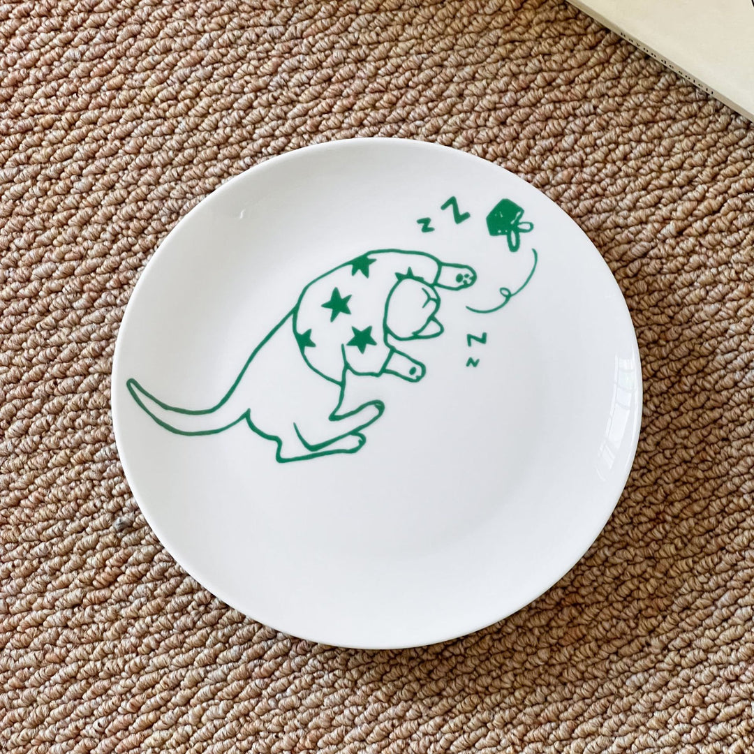 Decorative ceramic plate with cat motif and green border decoration