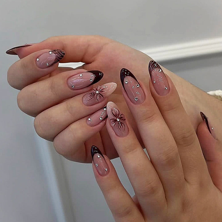 Acrylic nail set with elegant glitter and flower accents Kalsten