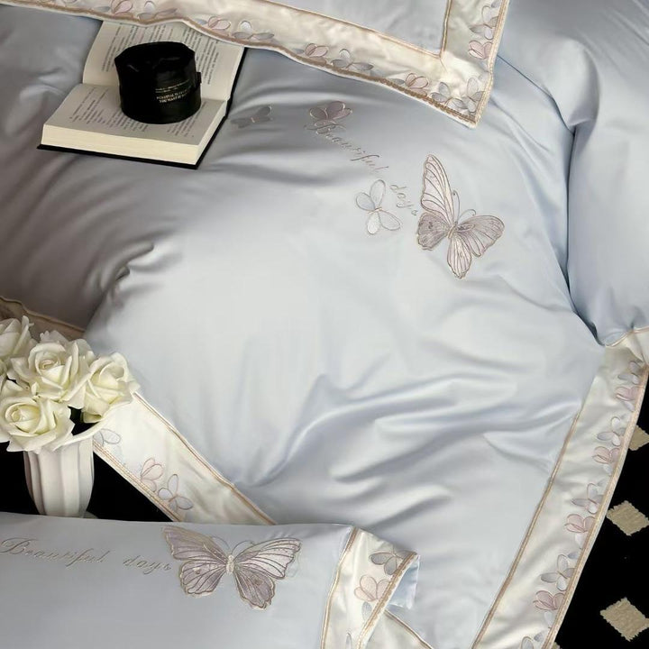 Satin bedding set with embroidered butterfly motif and silk-matte finish