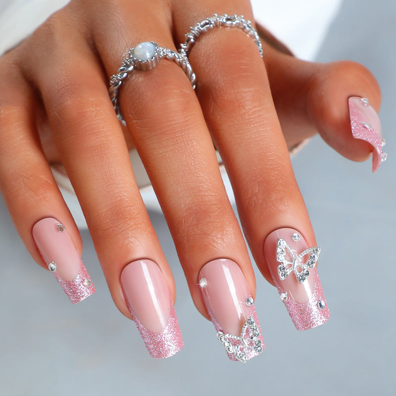 Acrylic nail set with sparkling glitter accents and elegant butterfly motifs Kalsten