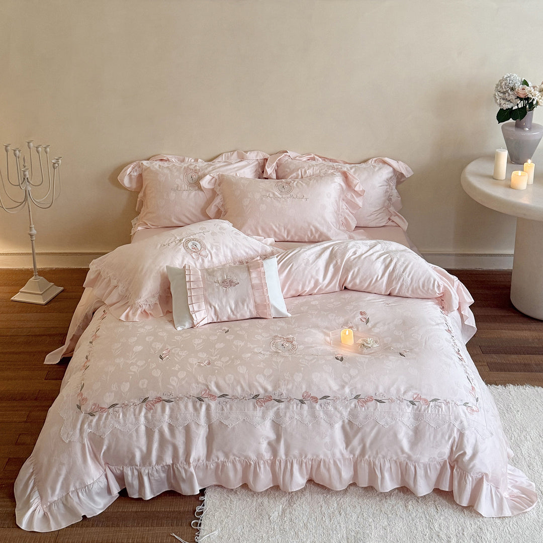 Romantic satin bedding set with embroidered floral design, ruffle and pillowcases