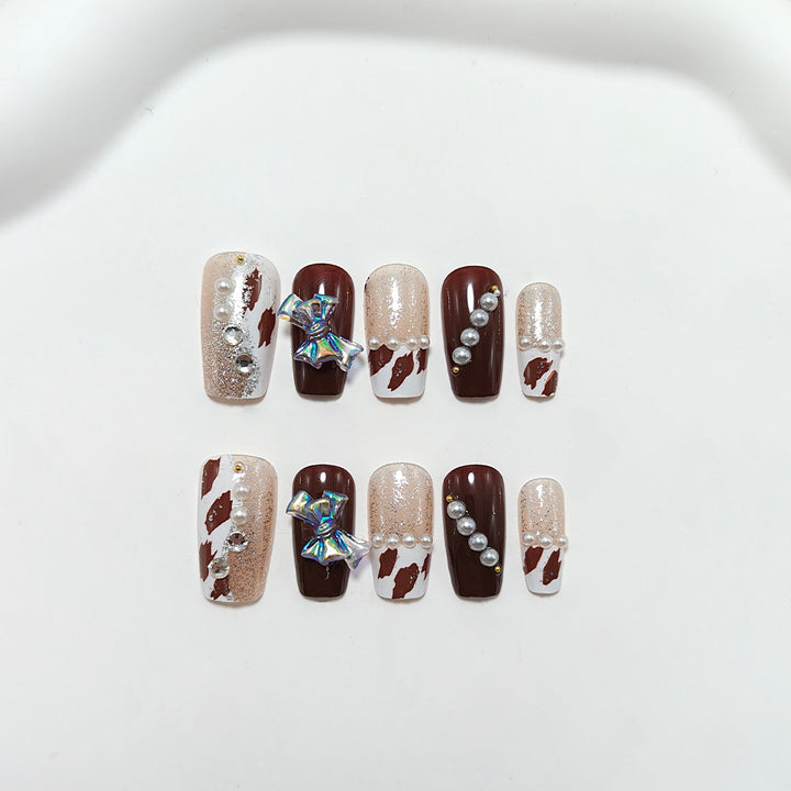 Artificial nails with glamorous rhinestone and bow design Kalsten