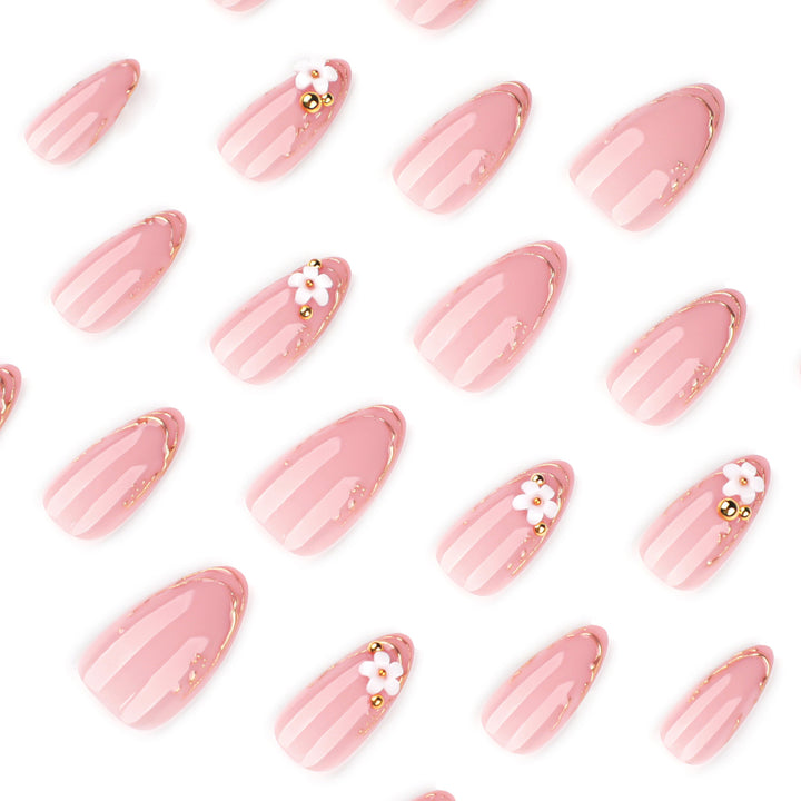 Artful nail design with golden accents and floral details Kalsten