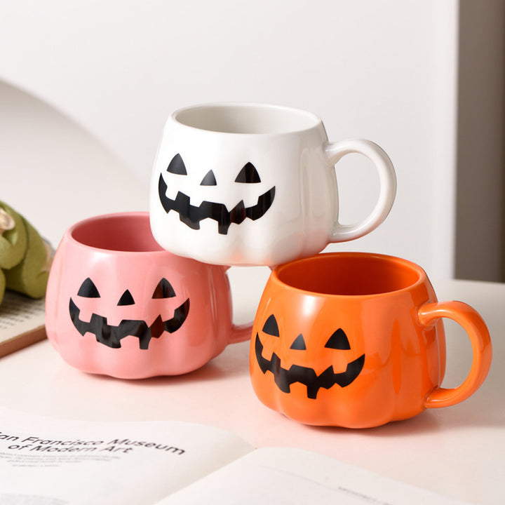 Ceramic mug in pumpkin shape with handle and carved face
