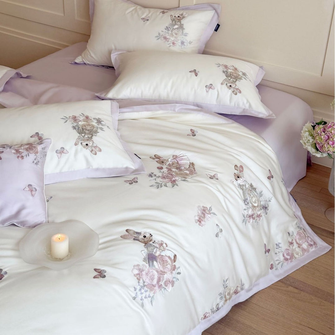 Finely embroidered bedding set with floral motifs and animal appliqués