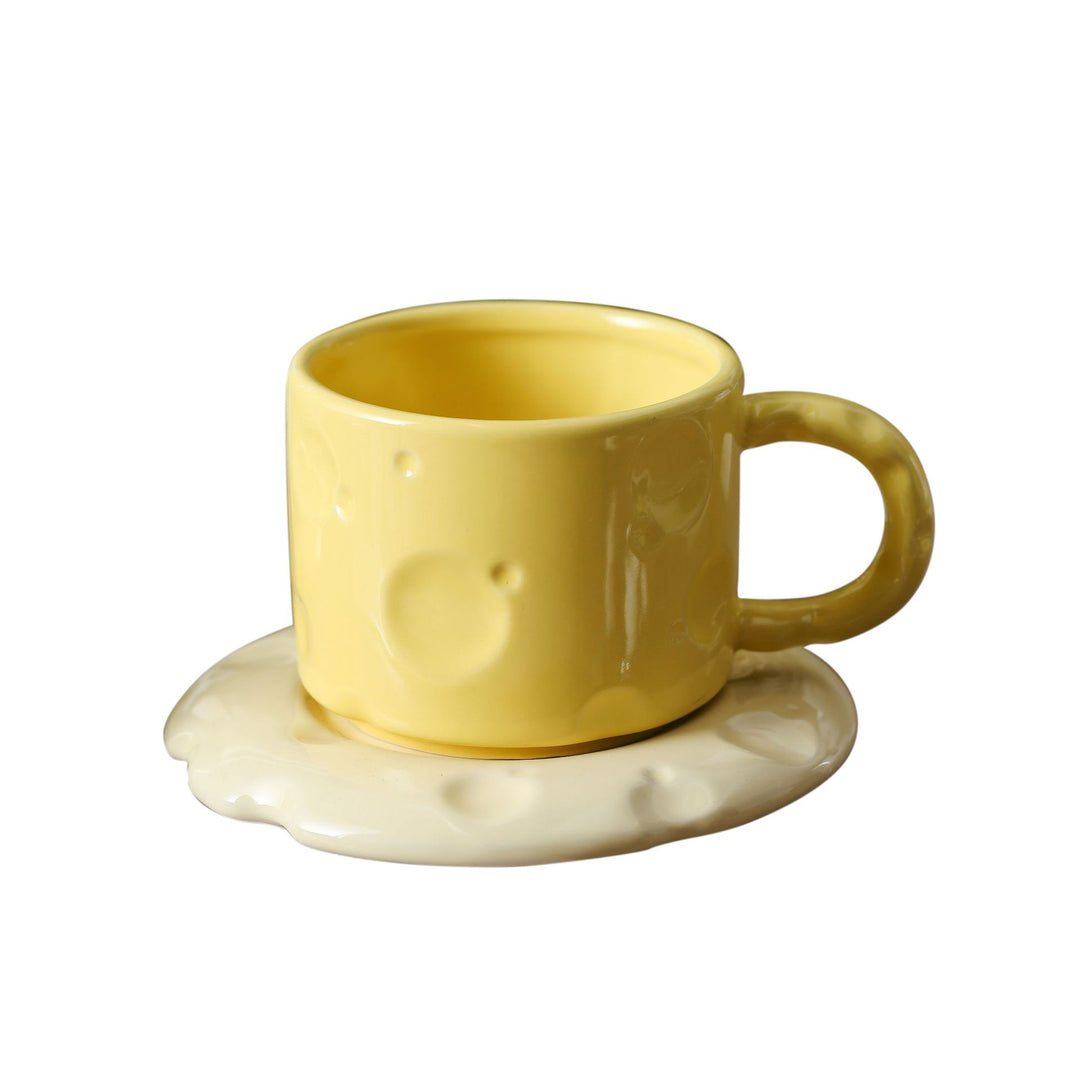 Ceramic coffee cup set with textured relief surface and wavy saucer