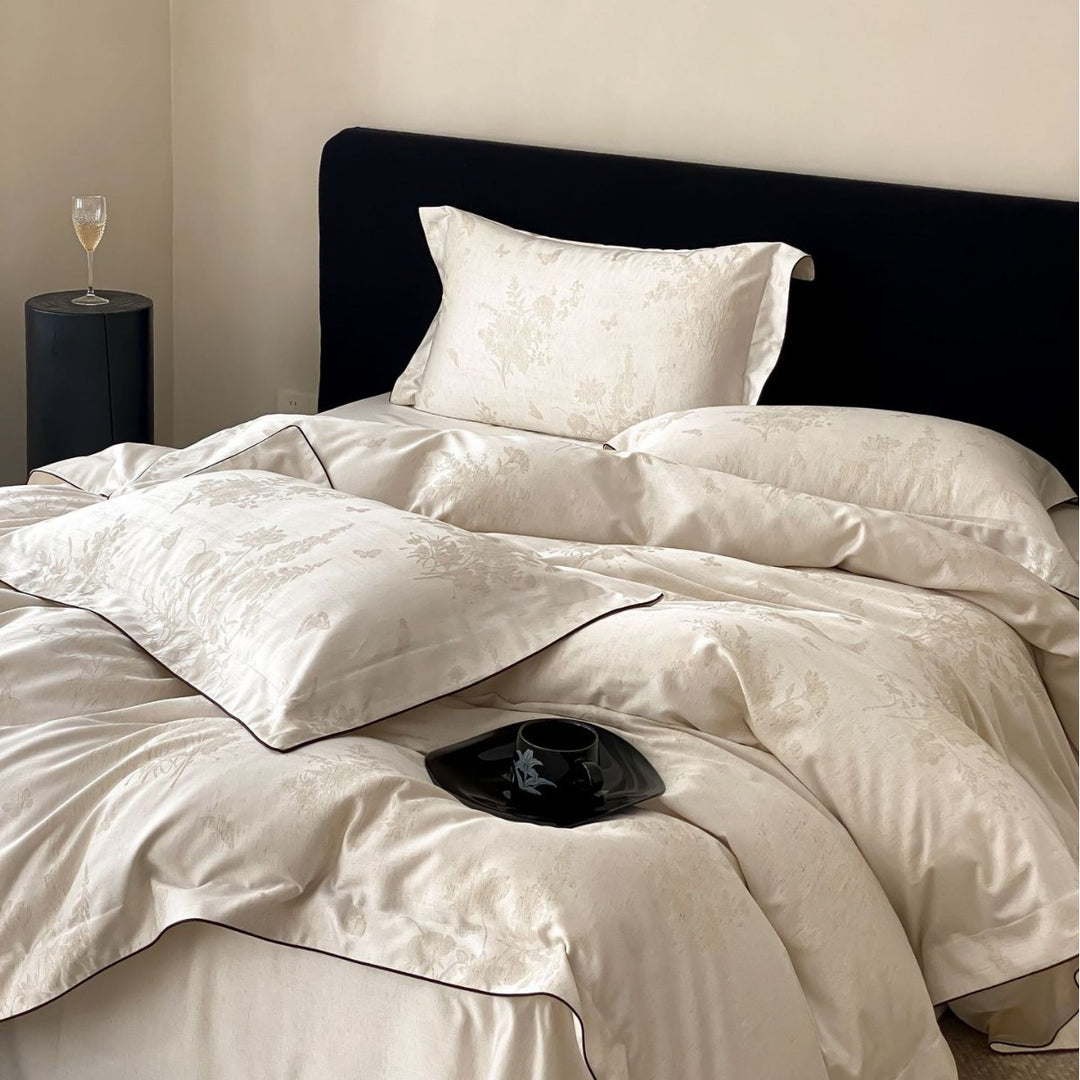 Finely woven cotton percale bedding set with subtle jacquard structure and contrast piping