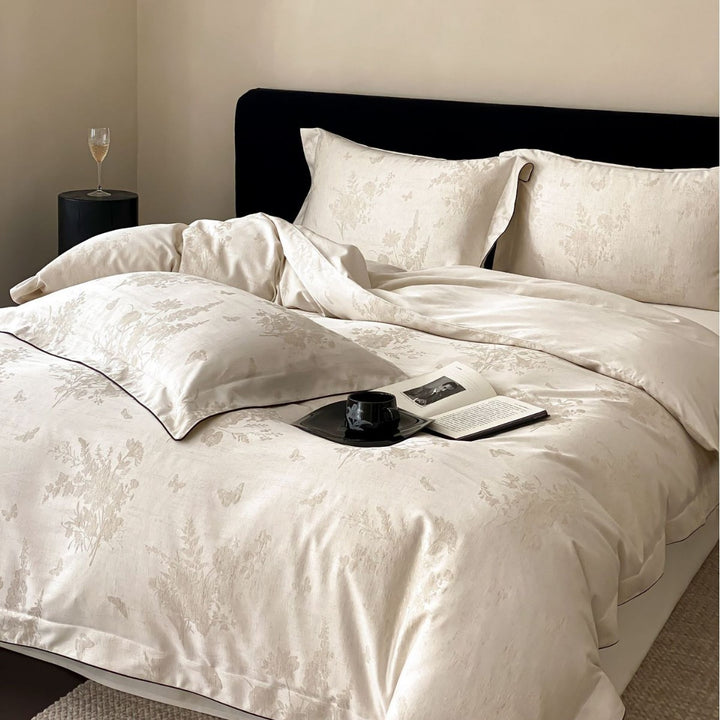 Finely woven cotton percale bedding set with subtle jacquard structure and contrast piping
