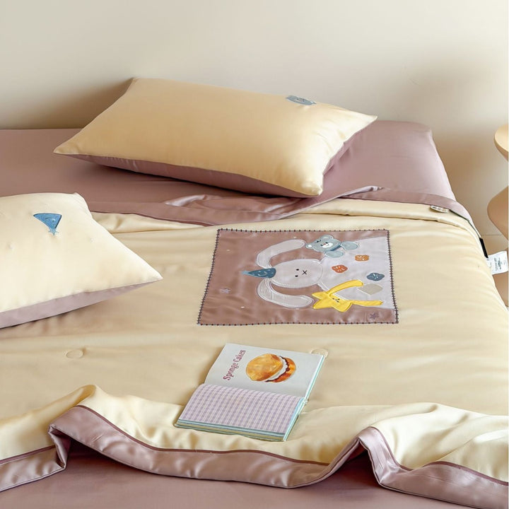 Satin bedding set with embroidered cat appliqués and silky soft finish