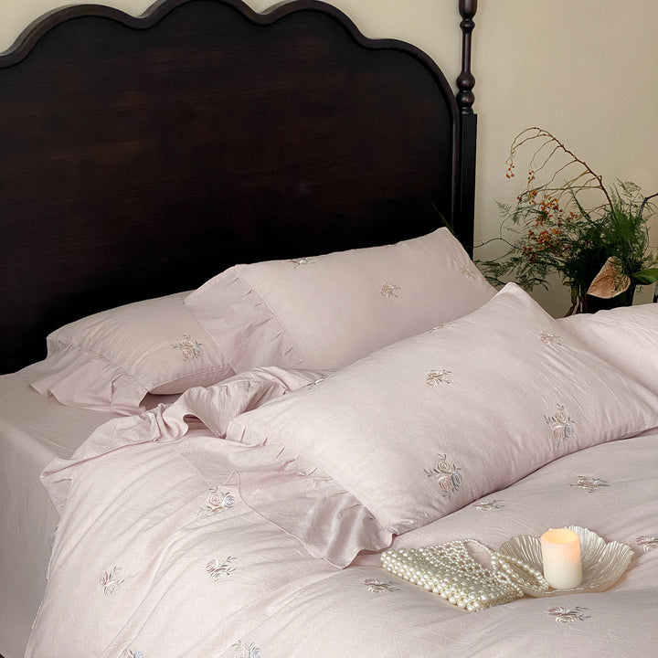 Vintage-inspired linen bedding set with fine rose embroidery and soft wash finish