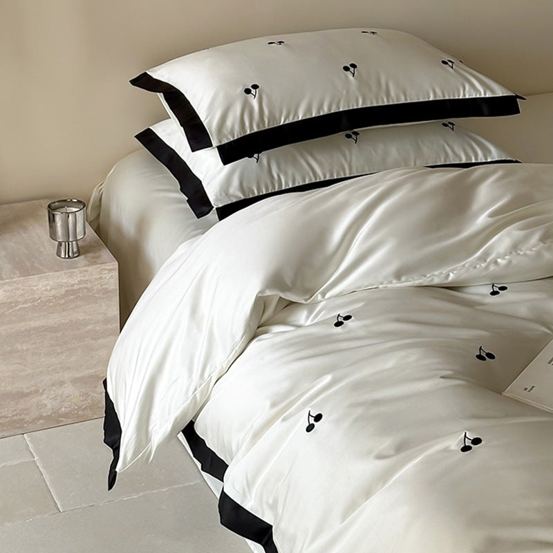 Luxurious satin bedding set with cherry embroidery and contrasting trim