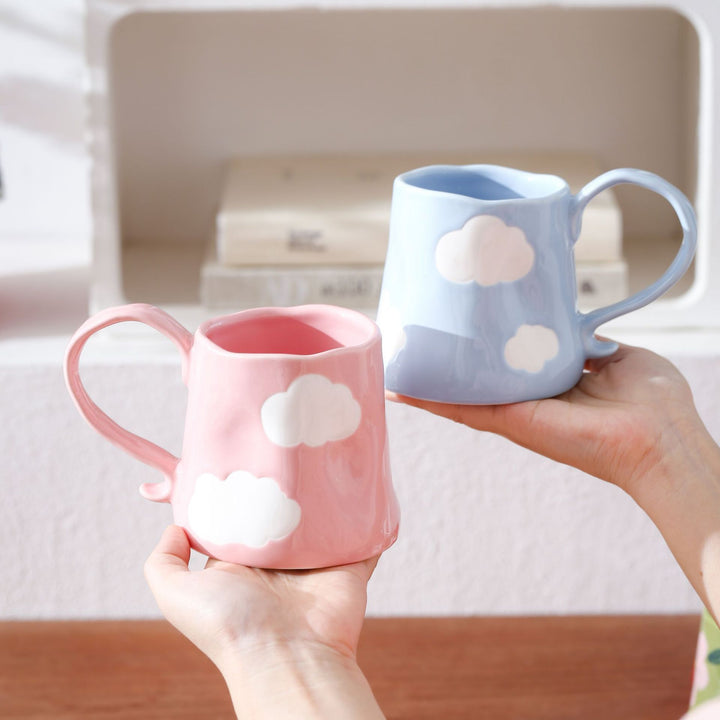 Hand-shaped ceramic mug with cloud relief and organic edge