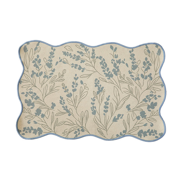 Shaped placemat made of cotton-linen with wavy edge and leaf pattern