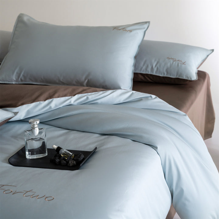 Reversible satin bedding set with fine tone-on-tone embroidery