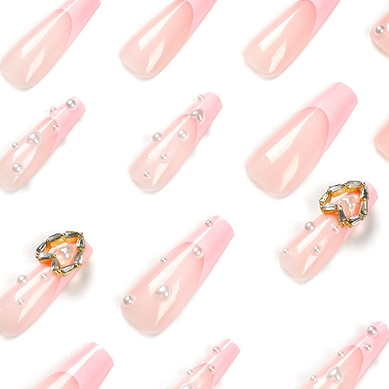 Artistic nail art with heart and pearl accents Kalsten