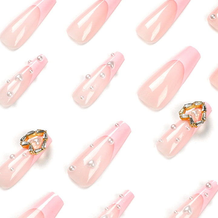 Artistic nail art with heart and pearl accents Kalsten